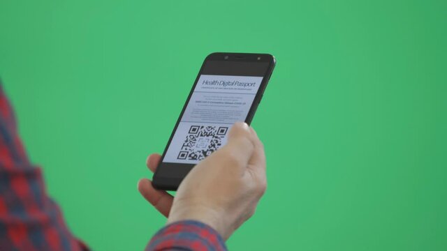 Hand searches smartphone for the digital health passport COVID-19 certificate