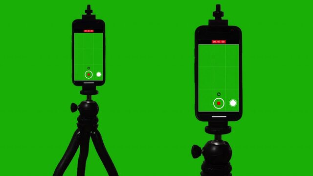 Smartphone Viewfinder Vertical Video Recorder On Tripod, Green Screen Background. Isolated smartphones mounted on a tripod is recording video on a green screen background for replacement