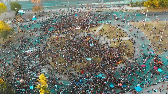SANTIAGO, CHILE - March 08, 2021 Aerial shot of hundreds of women demonstrate in commemoration of Women's Day this March 8 in Plaza Baquedano in downtown