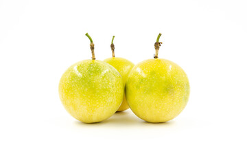 Closeup of multiple fresh golden passion fruit isolated on white background