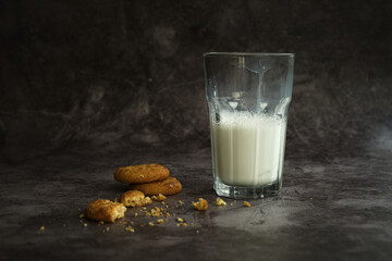 a glass of milk with cookies
