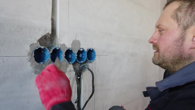 The electrician will plaster holes and channels for sockets and wires.