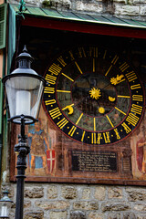 A large old clock on a tower in the center of the old town of Solothurn at the foot of the Weissenstein Jura mountains in Swiss alps. 
