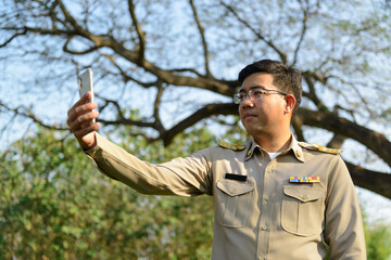 A Thai government officer, Civil servant is taking a selfie.