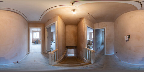 360 Degree panoramic sphere photo of construction work being done on an old British terrace house showing the hallway and main stairs with wooden floors in the house