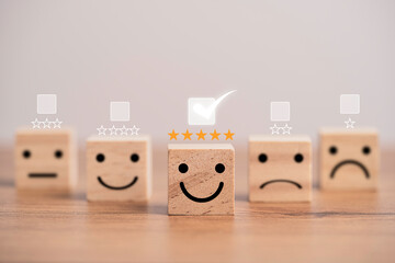 Customer satisfaction survey concept, human face icons print screen on wooden cube block with stars...
