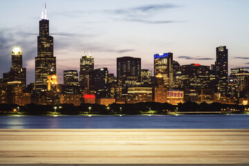 Blank wooden table top with beautiful Chicago skyline at evening on background, mockup