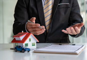 The real estate agent is explaining the house style to the clients who come to contact to see the...