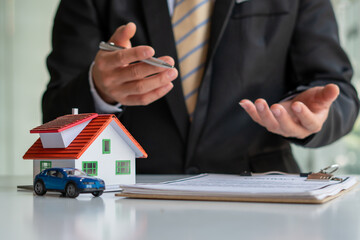 Buying a Home or Insurance, an insurance agent explains the lease agreement to a client before making a contract. Mortgage loan approval home loan and insurance concept.