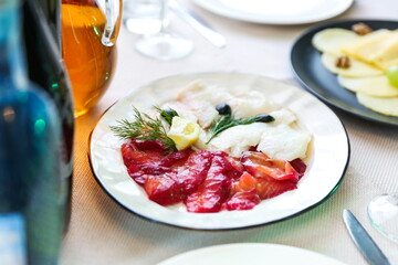 salt fish slices on a served table in a restaurant 