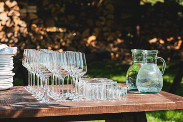 Wine glasses are lined up.Wedding banquet.Clean champagne glasses on the table.Glasses for water on the banquet table. Wine glasses at the birthday party.Empty glasses are lined up.Banquet preparation