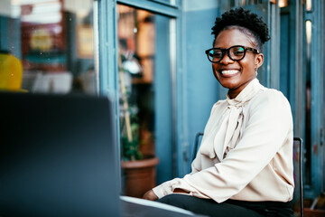 Businesswoman working in cafe. Beautiful woman with laptop in coffee shop.