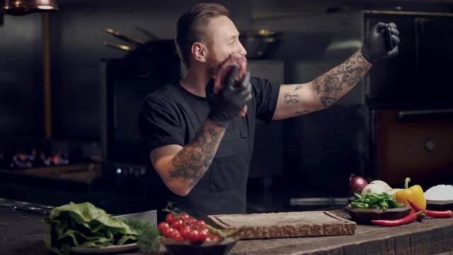 Chef cook making vlog on the smartphone. talking about meat preparation.