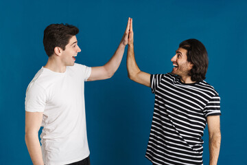 White excited two men exclaiming and giving high five