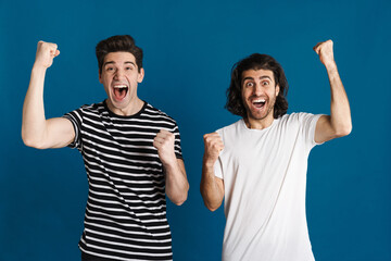 Fototapeta premium White excited two men exclaiming and making winner gesture