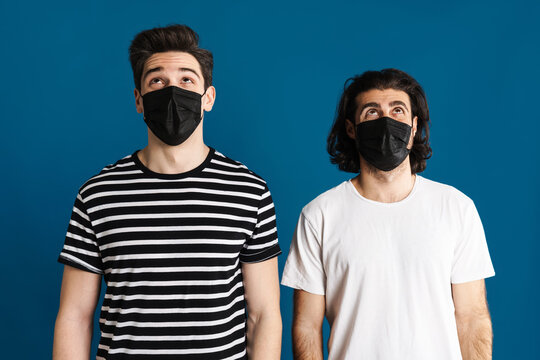 White Brunette Two Men In Face Mask Looking White Brunette Two Men In Face Mask Looking Upward