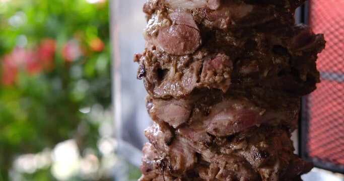 Traditional shawarma or kebab cooking on grill. Popular Levantine Arab snack