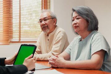 Happy Asian senior couple feel releif and pleasant after get the advice about family financial planning from professional financial advisor at home.