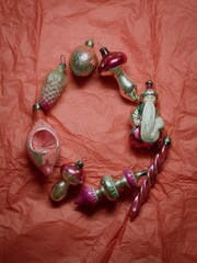 Vintage Christmas ornaments in a circle against red backdrop 