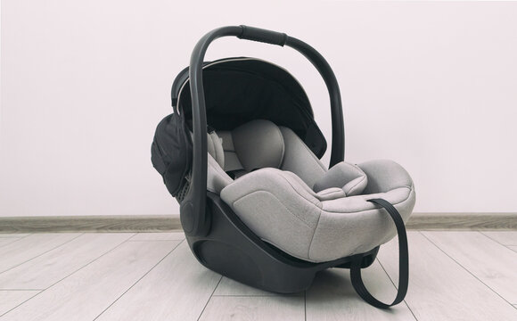 Empty baby car seat on the floor in the house