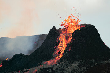 Volcanic eruption in Iceland, lava bursting from the volcano. 
Saturated red magma. 