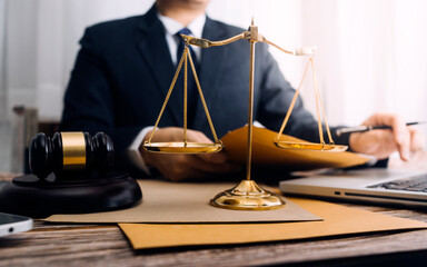 Business and lawyers discussing contract papers with brass scale on desk in office. Law, legal...