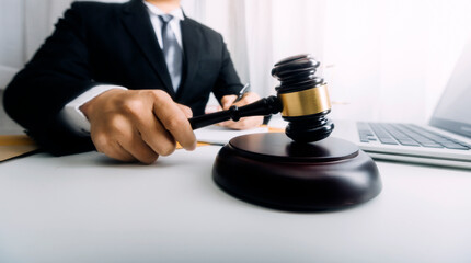 Business and lawyers discussing contract papers with brass scale on desk in office. Law, legal services, advice, justice and law concept picture with film grain effect