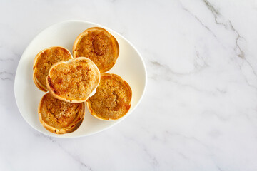 Traditional Portuguese pastry called Queijada de Sintra on marble background