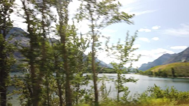 WATERTON, AB, CANADA - JULY 2019: Smooth & cinematic gimbal views of Lake & Peaks in Waterton National Park