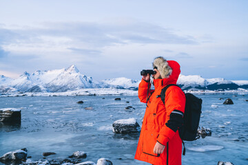 Tourist exploring wild Northern seashore