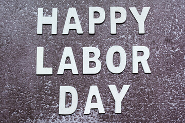 Happy labor day text on grunge grey concrete background. Labor day concept
