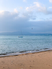 Fototapeta premium Beach view and sail in the distance
