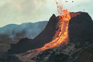 Volcanic eruption in Iceland, lava bursting from the volcano. 
Exploding lava. 