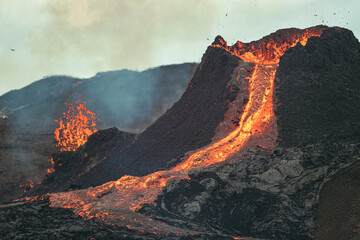 Volcanic eruption in Iceland, lava bursting from the volcano. Expending lava.  © Veniamin