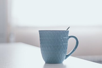 blue breakfast cup on white wooden table