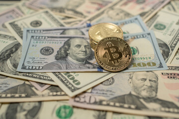 Bitcoin Crypto currency with US Dollar banknotes. Crypto Coins and 100 Dollar Bills. Digital...