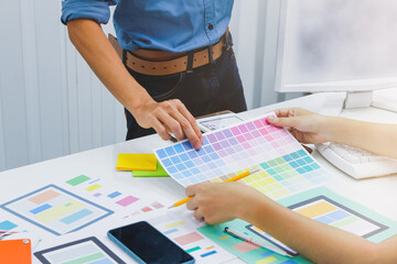 Web designers are working together to develop responsive website gear with UI UX Front End Designer...