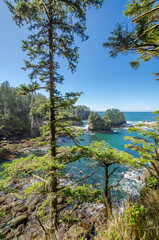 Ocean view with mountains, small island, blue sky and white clouds at summer day.