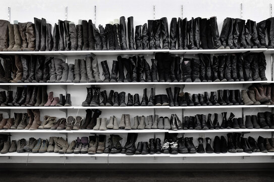 Rows of Old Used Women's Womens Boots and Shoes at Thrift Store