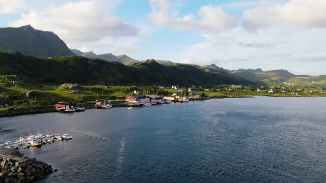 Aerial drone view towards a fisherman village, in Lofoten, Norway, golden hour