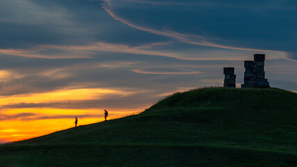 silhouette of a person walking on a hill