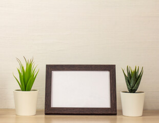 An empty photo frame on a table or shelf with a copy of the space.