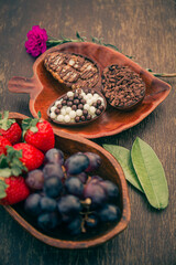 Elegant and rustic easter breakfast table with mini stuffed chocolate easter eggs and fruits on a wooden table. Gourmet. 