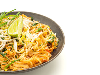 Pad Thai on a dish placed on a white background. Top view.