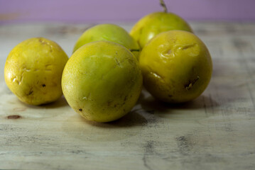 Yellow passion fruit (Passiflora edulis Sims) fruits on wooden construction background