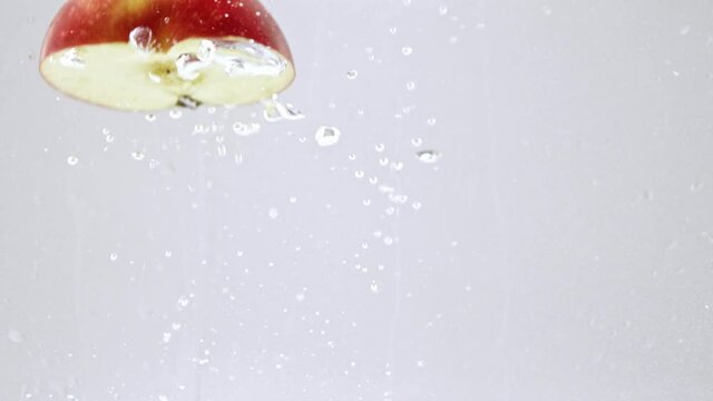 half of apple falling into fresh water