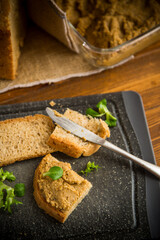 homemade meat pate with bread on a wooden table
