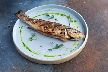 Grilled seabass in a plate.