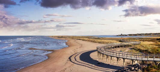 Panoramic view of a beautiful sandy beach on the Atlantic Ocean Coast. Sunset Sky Art Render. Taken...