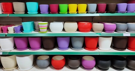 Many colorful ceramic and plastic flower pots at shop
